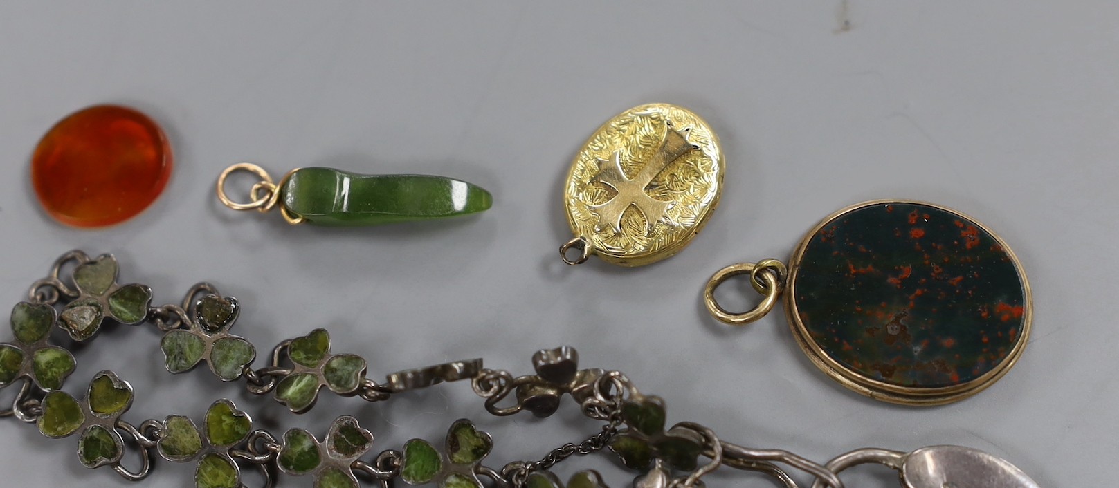 A small group of Victorian and later jewellery including a 1920's silver 'shamrock' bracelet, garnet set scroll brooch, bloodstone set mourning pendant(lacking back), small charms including enamel, sardonyx cameo etc.